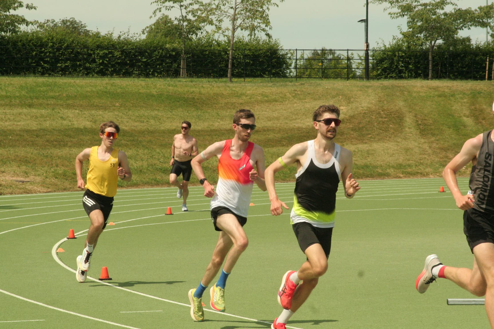 Athletes maintaining pace during an outdoor track interval